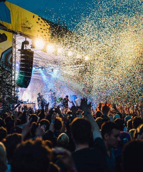 Confetti released from stage on a crowd of people in a music concert event