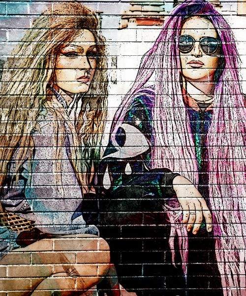 Graffiti on bricks wall of two women with long and pink hair sitting together
