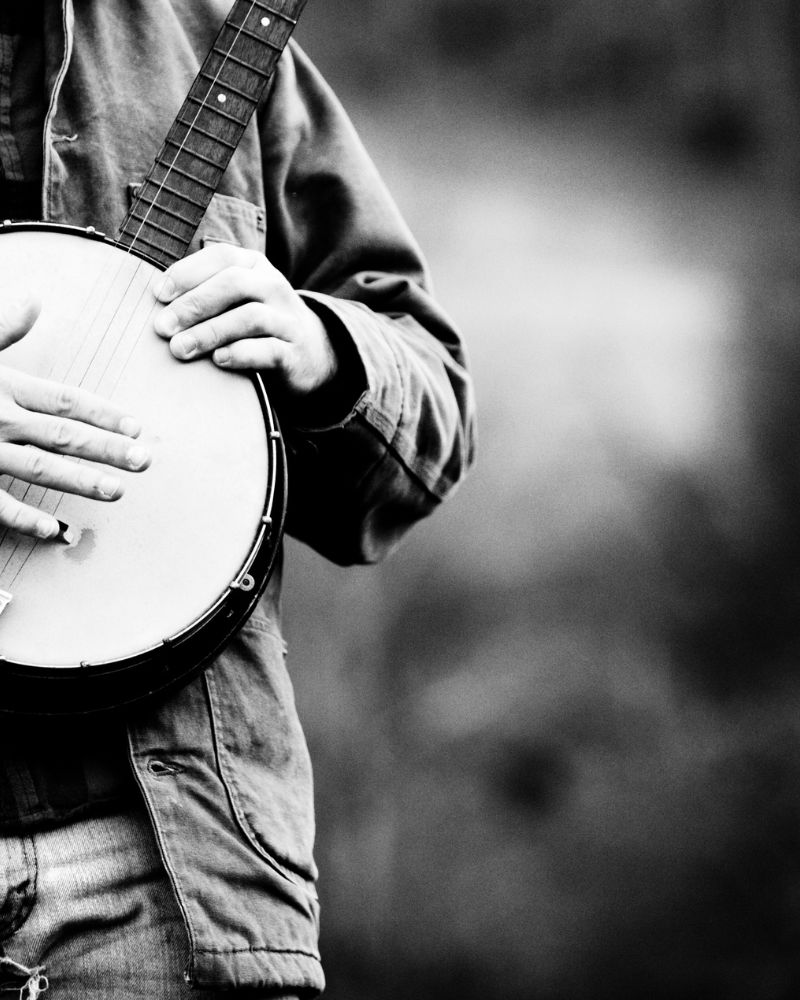 Man standing playing the Banjo